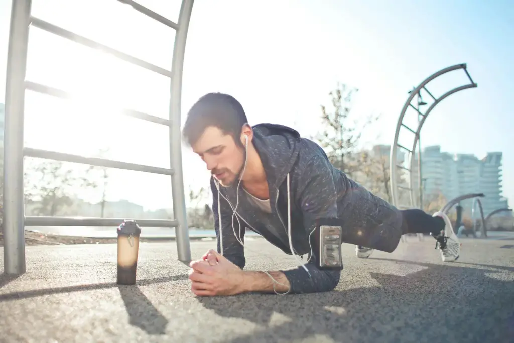 Man doing a plank exercise outdoors.